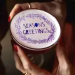 Printed cocktail with the phrase 'season's greetings'