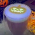 Picture of a latte with a printed glow-in-the-dark jack-o-lantern on top