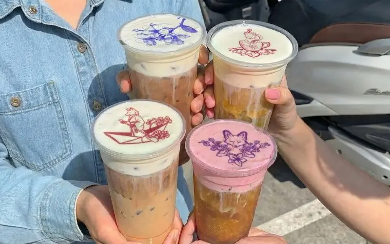 Four summer-themed iced lattes topped with cold foams and prints from the Ripple Maker drink printer.
