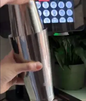 Shaking a cocktail shaker in front of a cocktail printer