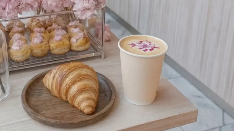coffee printed with a cherry blossom on a cafe counter